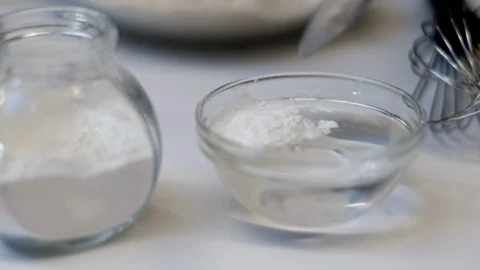 Putting the yeast in the water - Activation. Stock Footage 89538392