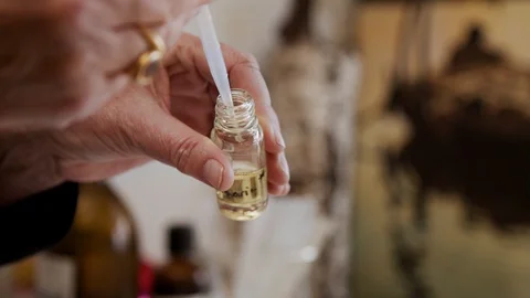 Putting Yellow Liquid into Small Bottle with Pipette Vídeos de archivo 111755601