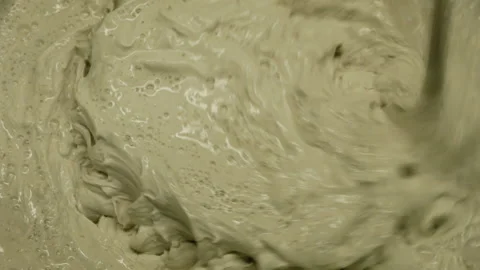 Putty mixing. Builder mixes plaster in a bucket using an electric mixer. Stock Footage 146379793