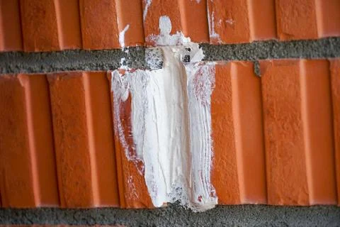 Puttying the brick walls of a multi-storey building with special dry mixes an Stock Photos