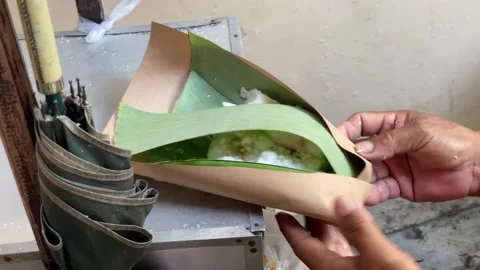 Putu Bambu is a warm, sweet, steamed, cylindrical rice cake with a sweet palm Stock Footage 317542872