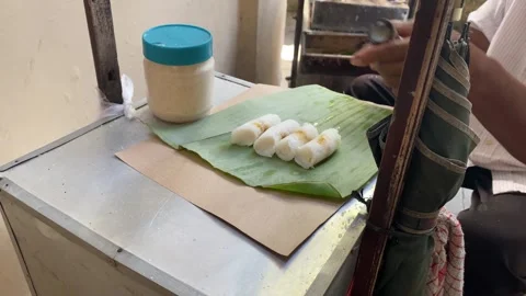 Putu Bambu is a warm, sweet, steamed, cylindrical rice cake with a sweet palm 스톡 동영상 317542893