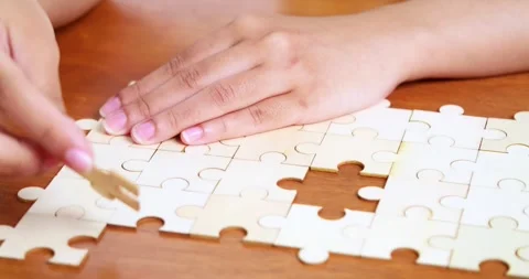 Puzzle assembly activity home hobbyist content indoor close-up view focus 스톡 동영상 313934513