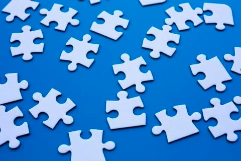 Puzzle on blue table Stock Photos