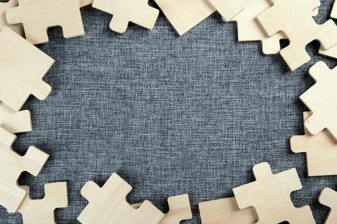 Puzzle elements on a textile background as a riddle 스톡 사진