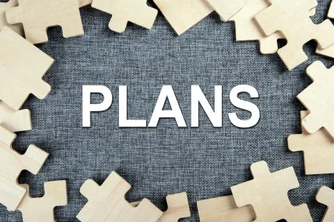 Puzzle elements on a textile background as a riddle and inscription plans Stock Photos