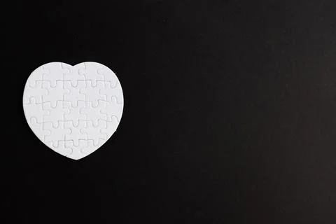 Puzzle heart with one missing piece on black, health care concept Stock Photos