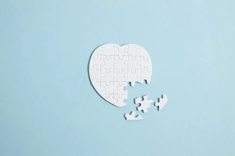 Puzzle heart with one missing piece on blue, health care concept Stock Photos