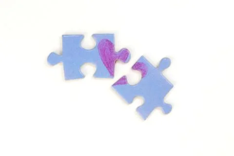 Puzzle with a heart on the withe background. Stock Photos