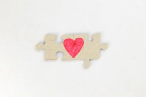 Puzzle with a heart on the withe background. Stock Photos