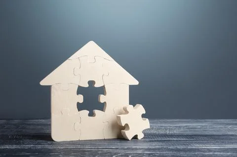 Puzzle house with a missing part. Housing construction, design and engineer.. Stock Photos