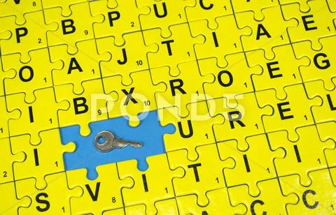 Puzzle letters and key Stock Photos