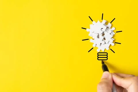 Puzzle lightbulb represents innovation, creative or brainstorming concept Stock Photos