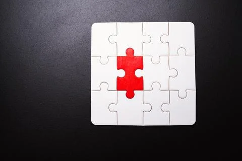 A puzzle piece with a red piece missing Stock Photos