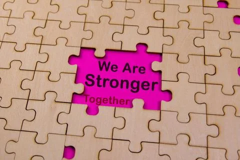 Puzzle pieces forming a message of unity and strength Stock Photos