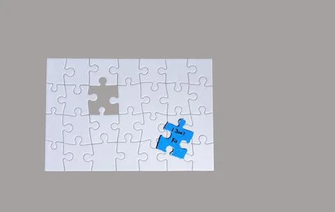 Puzzle Pieces on a Light Gray Background With One Blue Piece Near a Missing.. Stock Photos