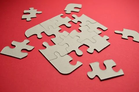 Puzzle pieces on a red background Stock Photos