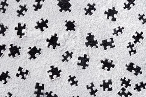Puzzle shapes pattern printed on white flour sand, powder on dark table. Natu Foto stock