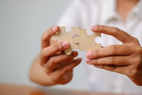 Puzzle solving activity home image of hands indoor close-up creativity action Stock Photos