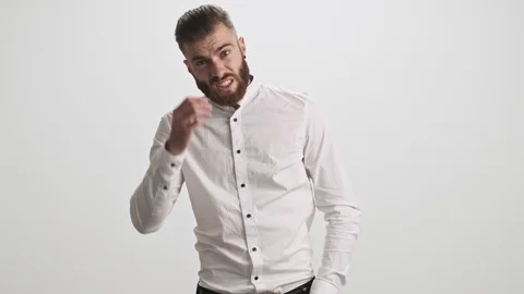 Puzzled bearded man is touching his forehead isolated over white wall background Stock Footage 125320501