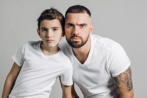 Puzzled daddy and his son with clueless expression looking at the camera Stock Photos