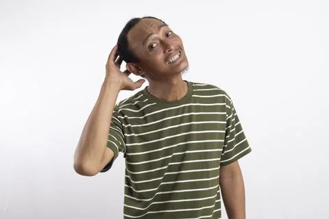 Puzzled guy scratches head, thinks deeply about something, has indignant lo.. Stock Photos
