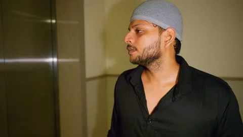 Puzzled guy tries elevator switch once again Stock Footage 310285054