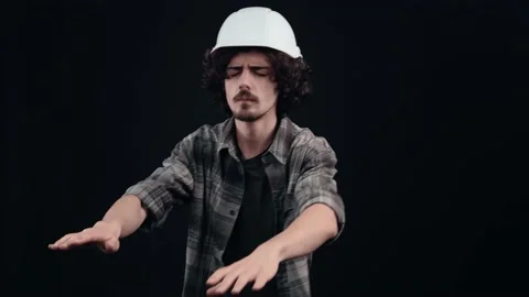 Puzzled hipster with outstretched hands looking for things in the dark. Young Stock Footage 150462746