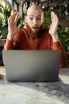 Puzzled indignant redhead man feels confused software problems, data loss, ra Stock Photos