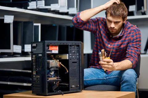 Puzzled man scratching his head, holding tools Stock Photos