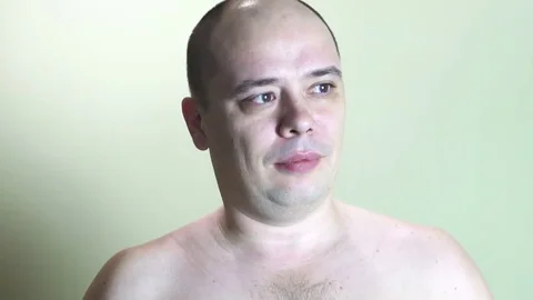 Puzzled man stands in the background of the wall Stock Footage 72572893