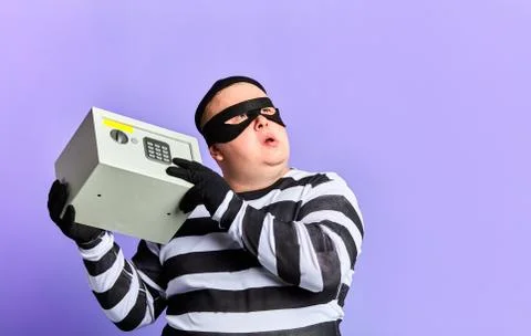Puzzled pensive prisoner trying to remember the pin code of a safe Stock Photos