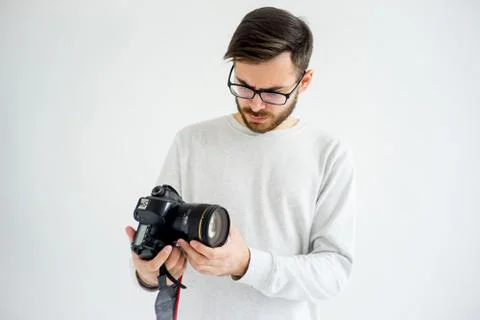 Puzzled photographer with camera Stock Photos