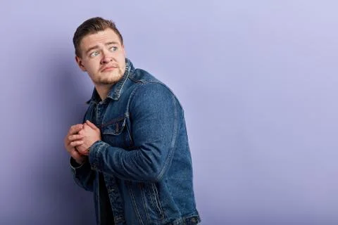 Puzzled shocked scared man standing in the cormer of studio Stock Photos