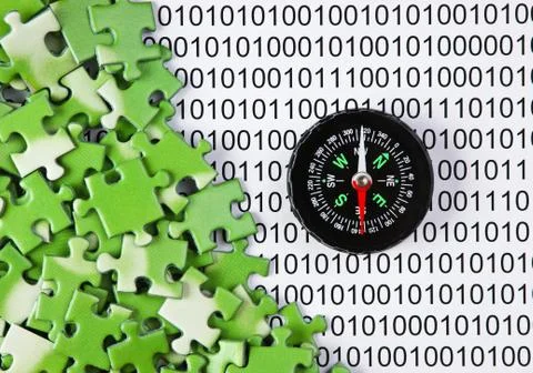 Puzzles and compass on a binary code Stock Photos