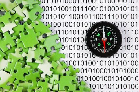 Puzzles and compass on a binary code 스톡 사진