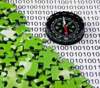 Puzzles and compass on a binary code Stock Photos