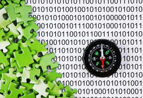 Puzzles and compass on a binary code Foto stock