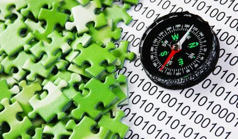 Puzzles and compass on a binary code 库存照片
