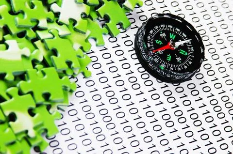 Puzzles and compass on a binary code Foto stock