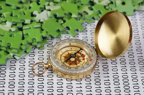 Puzzles and compass on a binary code 스톡 사진