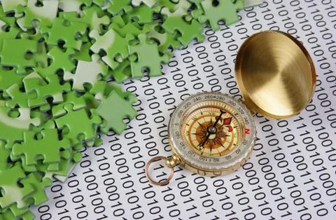 Puzzles and compass on a binary code 스톡 사진