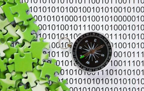 Puzzles and compass on a binary code Stock Photos