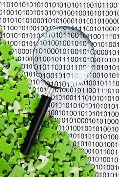 Puzzles and magnifying glass on a binary code 스톡 사진