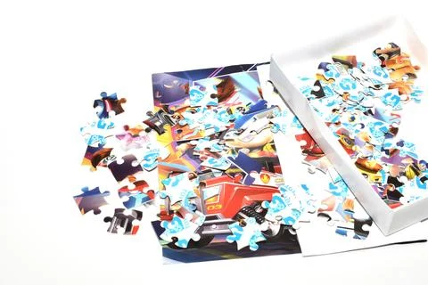 Puzzles are scattered on the table. Stock Photos