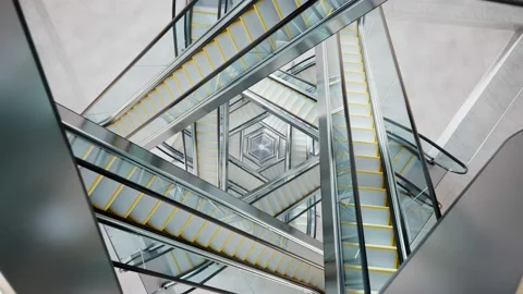 Puzzling labyrinth of escalators made of glass and steel. Complicated passages. Video stock 145763501