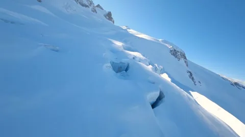 PV drone closely flies over a glacier and its crevasses on a French mountain Stock Footage 253554398