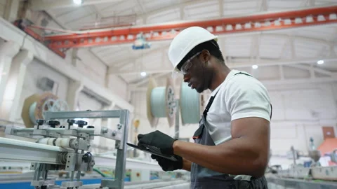 PVC factory worker engineer is using a tablet with an engineering software on Stock Footage 270104989