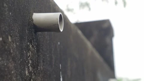 PVC pipe protruding from dark mossy concrete wall Vidéo 337292044
