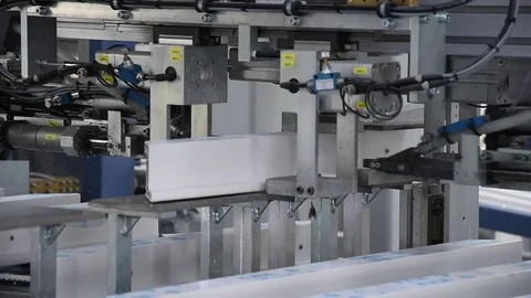PVC windows and doors sections on the automatic line machinery for screws -dolly Stock Footage 75575233